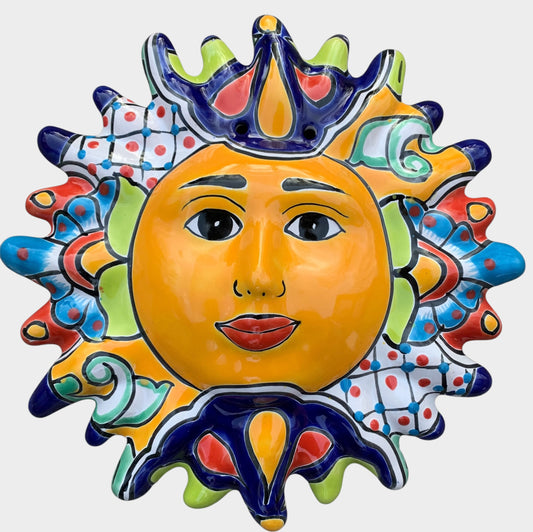 Decorative Talavera sun-shaped wall art with colorful face design on a white background