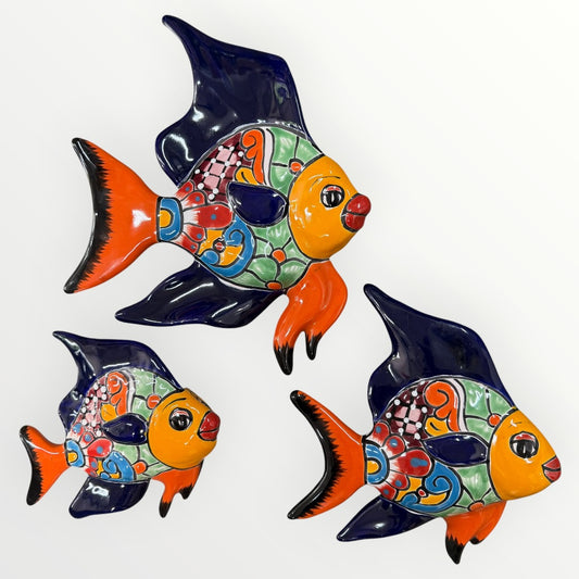 Three colorful fish-shaped wall decorations on a white background
