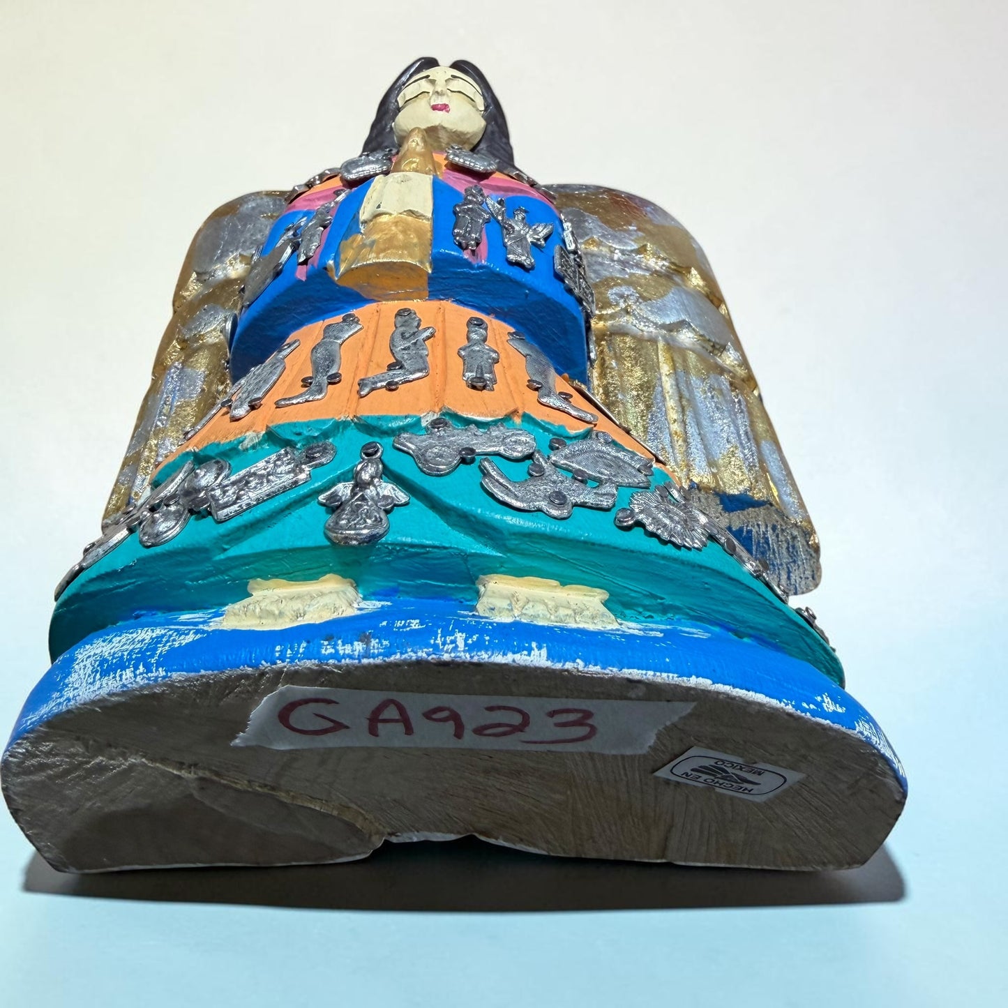 Milagros guardian angel displayed at an angle showing her charms.