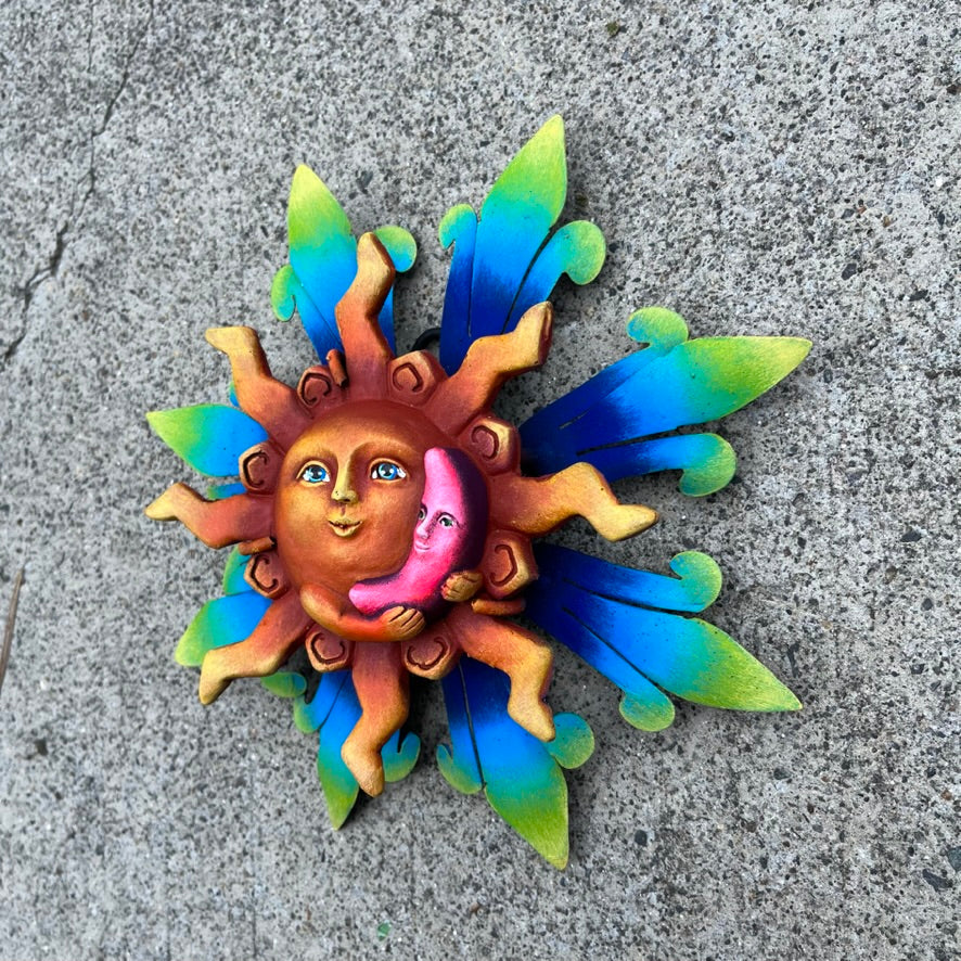 Sun holding pink moon metal art moon side