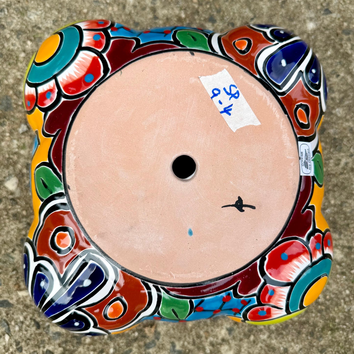Hand painted Mexican Talavera Strawberry pot with a large top opening a four pockets on each side. Trim color is cherry red, body has multi-color designs on each side. Photo shows drain hole on the bottom.