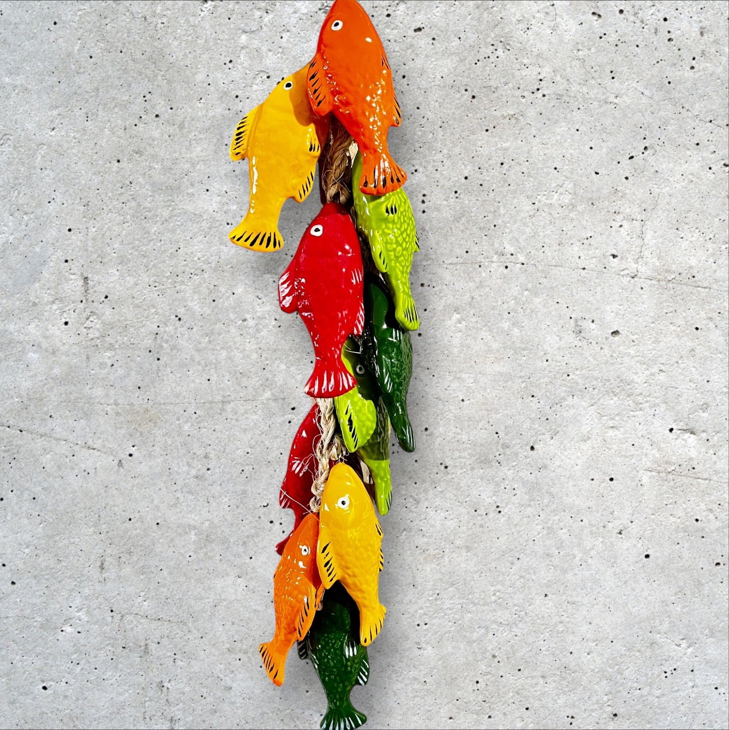 Ceramic colorful fish on a string bundle