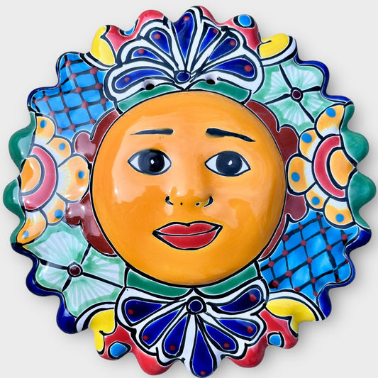 Decorative talavera wall Sun with a colorful face design on a white background