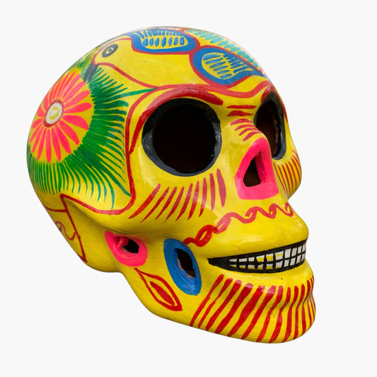 Colorful Mexican Sugar skull yellow with vibrant designs on a white background