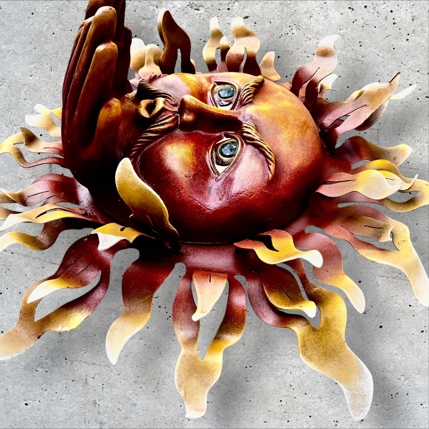 Metal wall art sun with hands side view