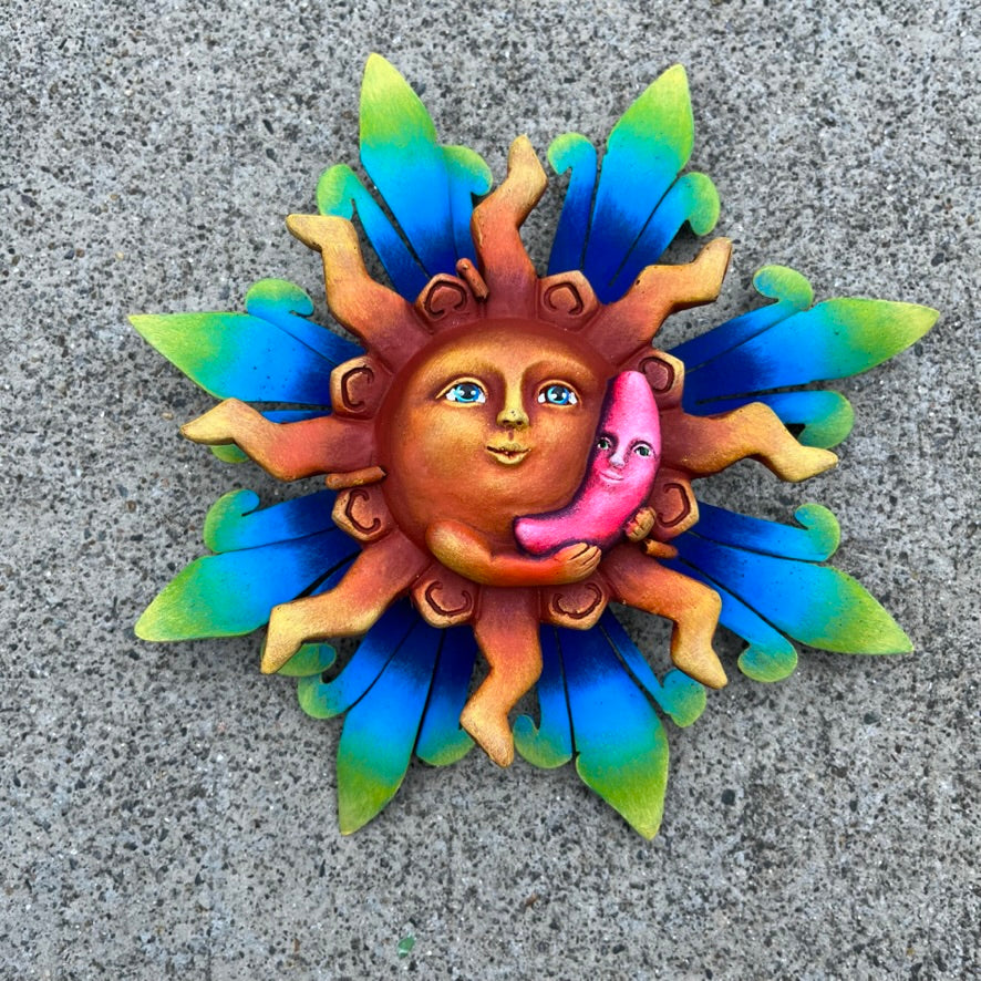 Sun holding pink moon metal art front