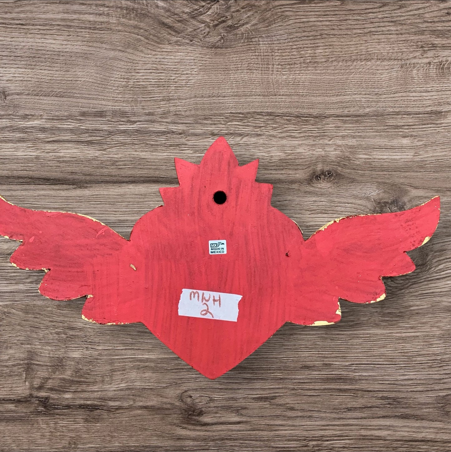 Milagros decorated sacred heart with wings back