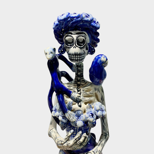Frida and friends Catrina in classic blue and white. Friends include a monkey and parrot on her shoulders