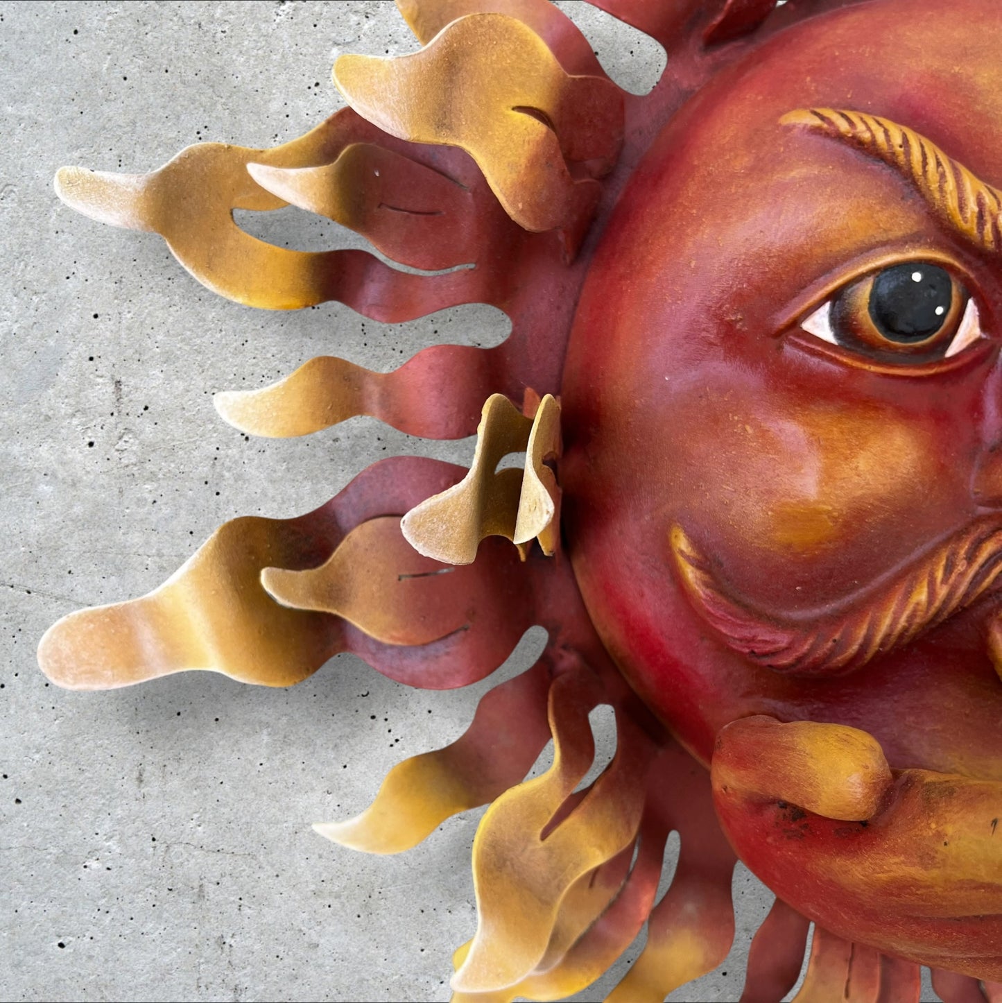Metal wall art sun with hands rays