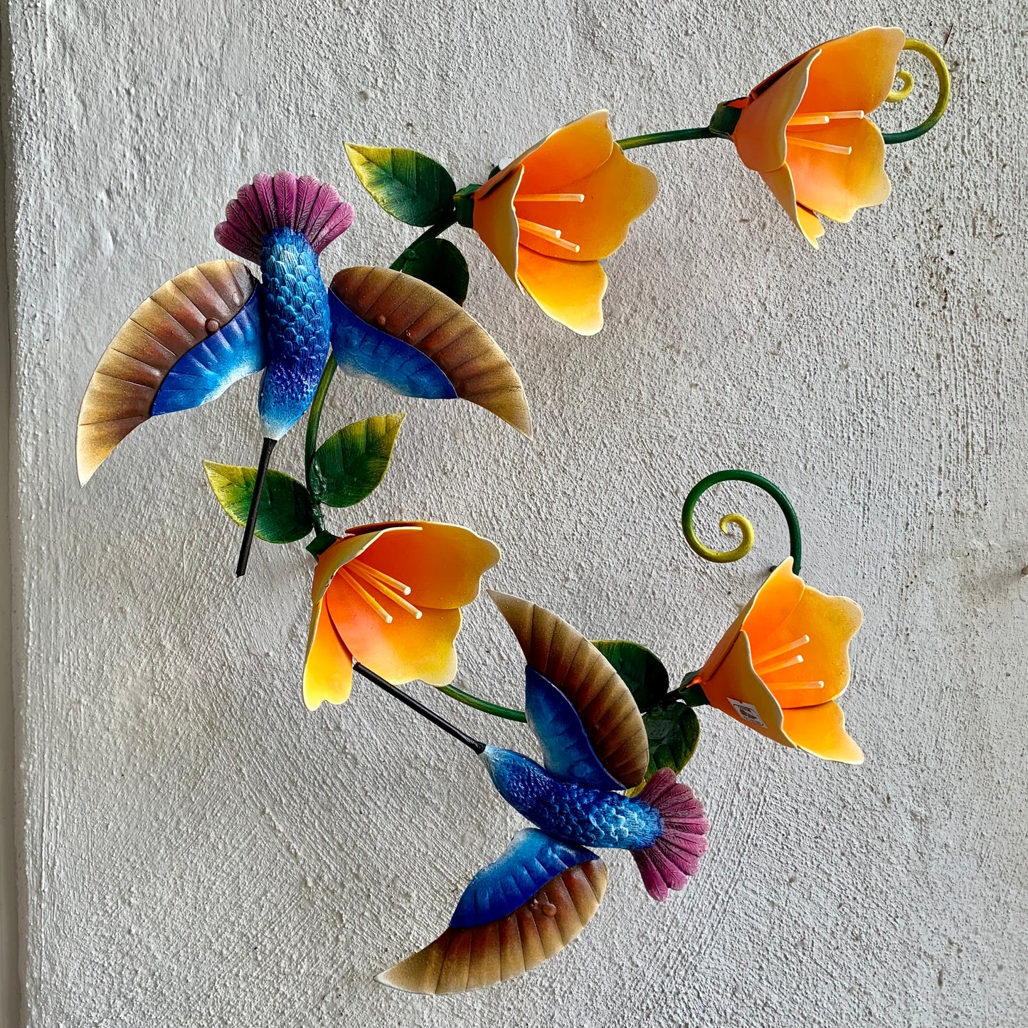 Hummingbirds with yellow flowers sculpture