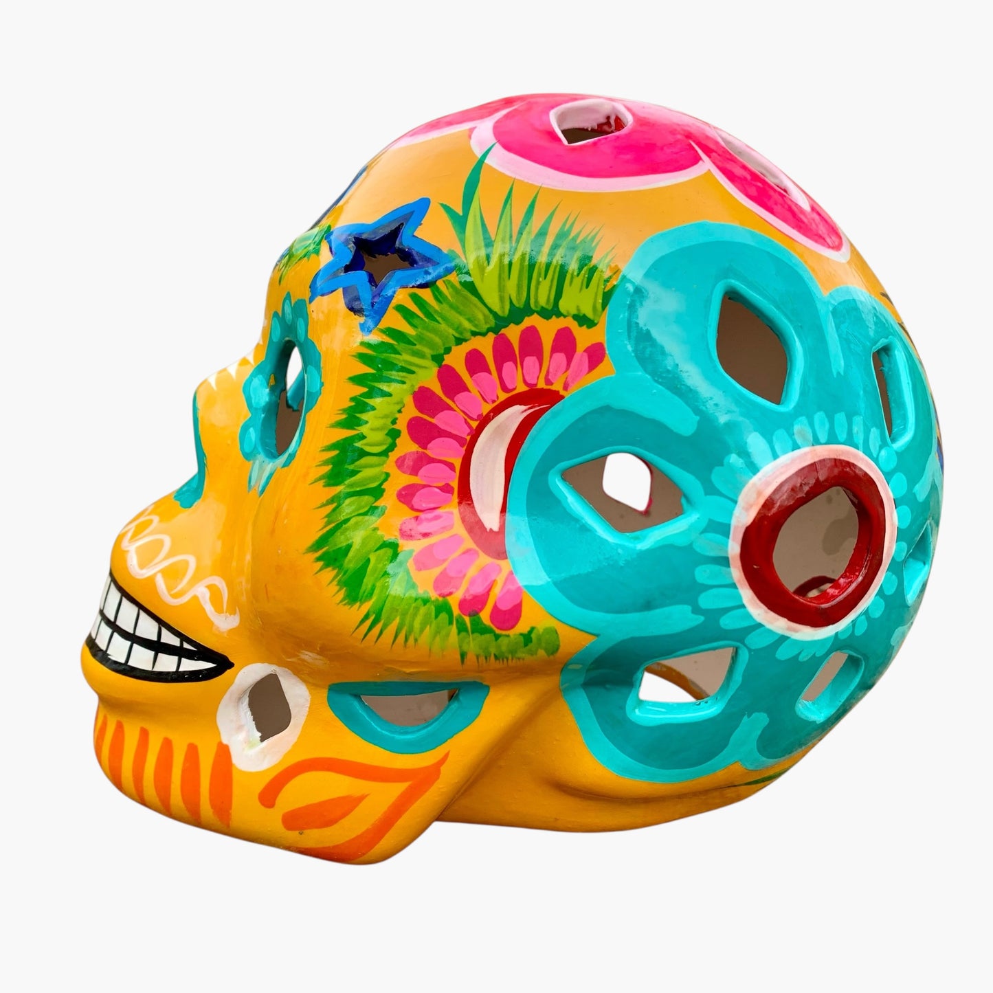 Colorful Mexican Sugar skull yellow with vibrant designs on a white background side view