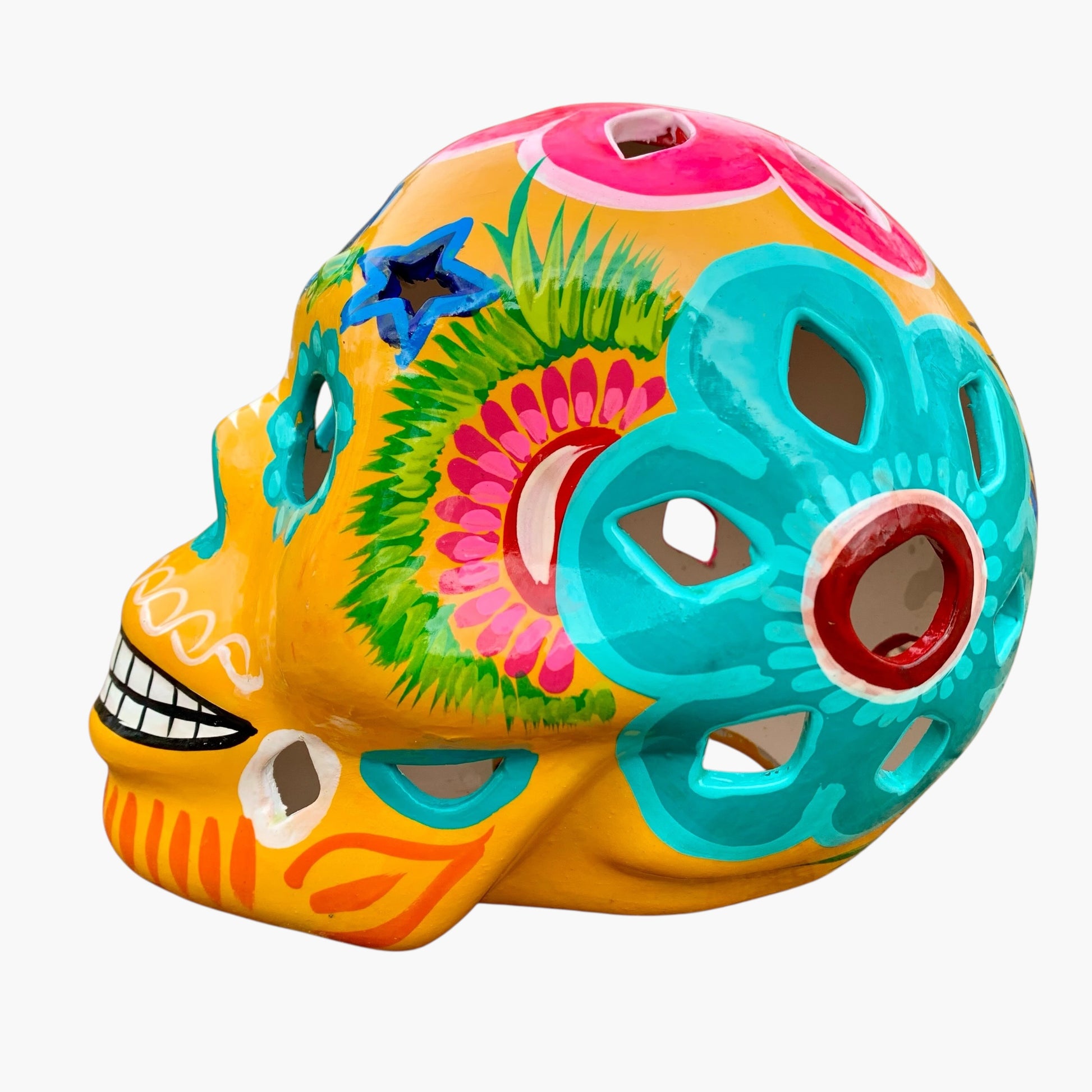 Colorful Mexican Sugar skull yellow with vibrant designs on a white background side view