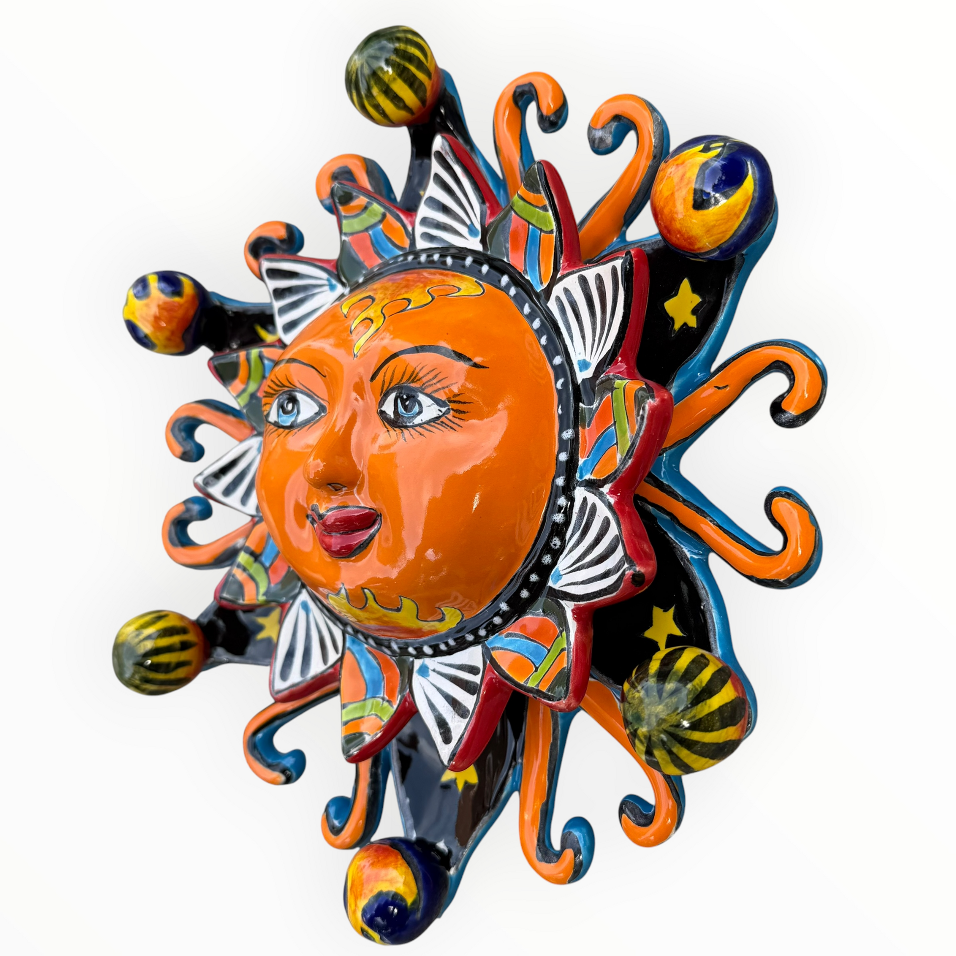 A colorful hand-painted Talavera ceramic sun wall decor piece with a smiling face, orange center, planets, and multicolored rays on a plain white background right side view.