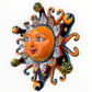 A colorful hand-painted Talavera ceramic sun wall decor piece with a smiling face, orange center, planets, and multicolored rays on a plain white background right side view.