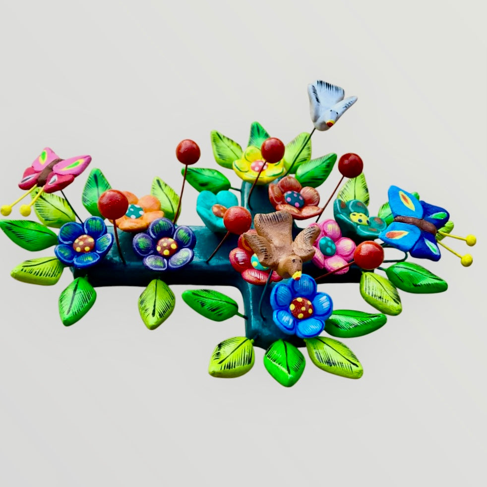 Ortega Pottery Folk art cross with leaves, flowers and butterflies three dimensional side view.