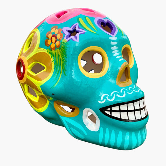 Colorful Mexican Sugar skull teal with vibrant designs on a white background