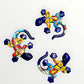 Three colorful Talavera ceramic lizards on a white background