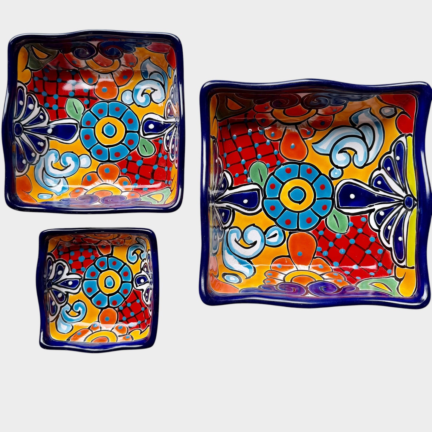 Three colorful talavera square nesting bowls with intricate patterns Shown unnested.