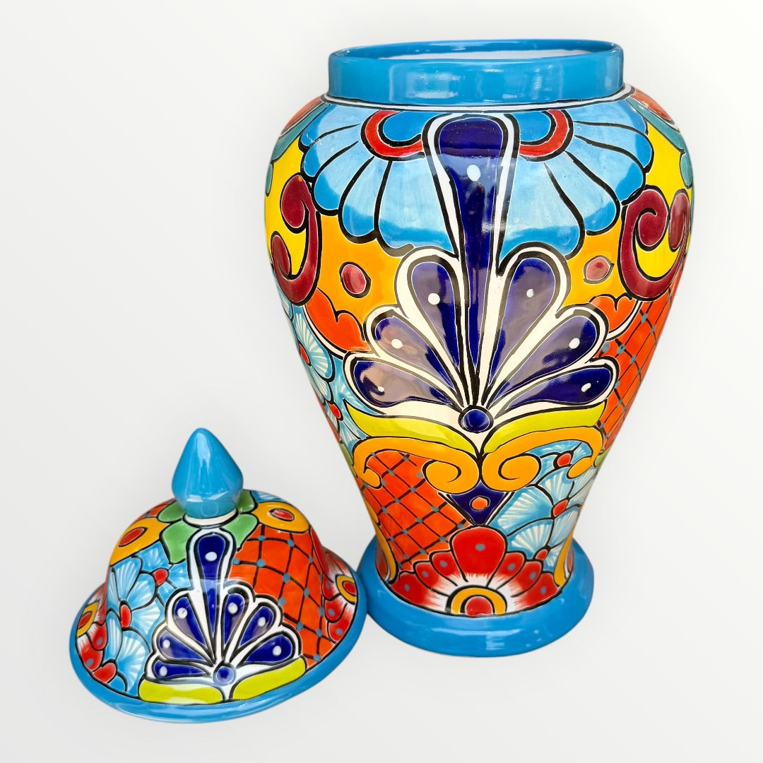 Colorful Mexican Talavera ceramic jar with lid decorated with intricate multicolor traditional patterns With lid off