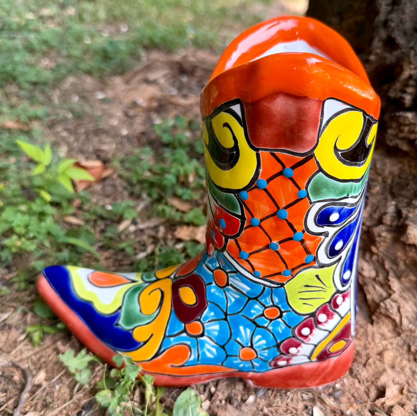 Orange, cowboy boot planter side view