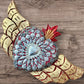 Winged Milagros sacred heart with center heart charm surrounded by sea shells 