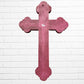 Decorative Milagros wood cross with many charms “miracles” on a white brick wall background Back