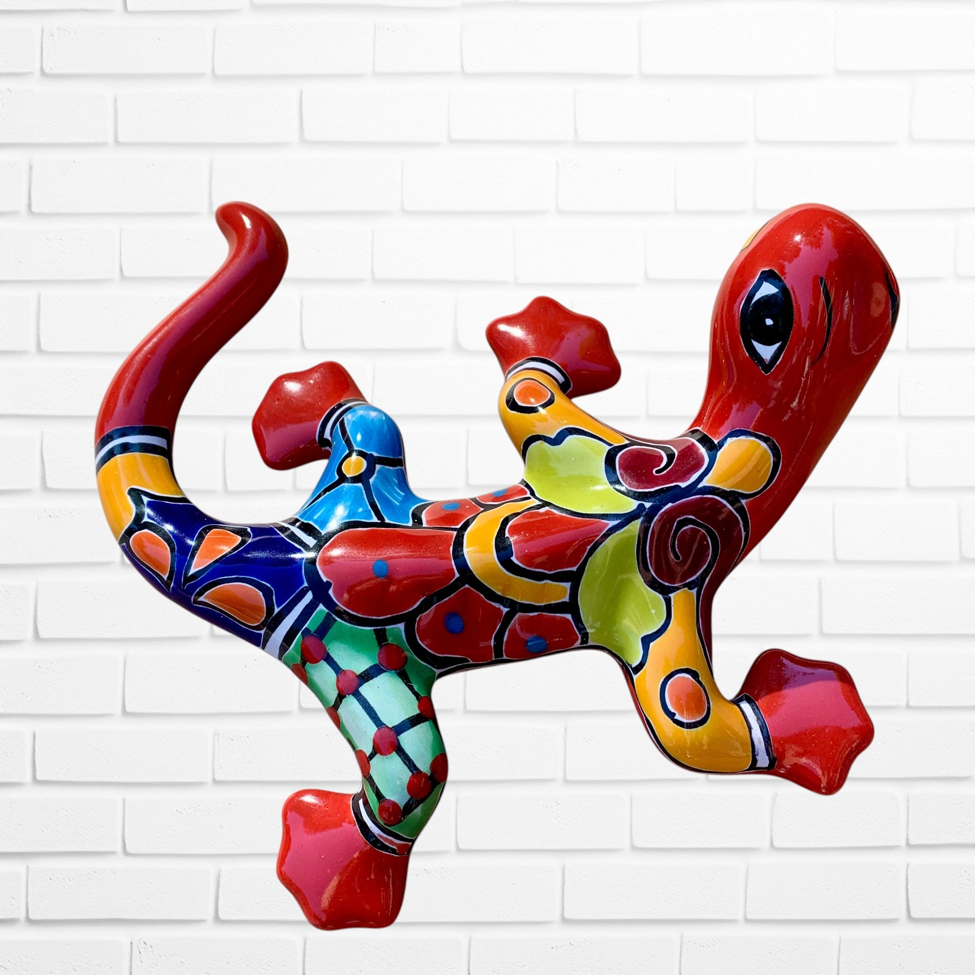 Colorful abstract dog sculpture against a white brick wall background left side view