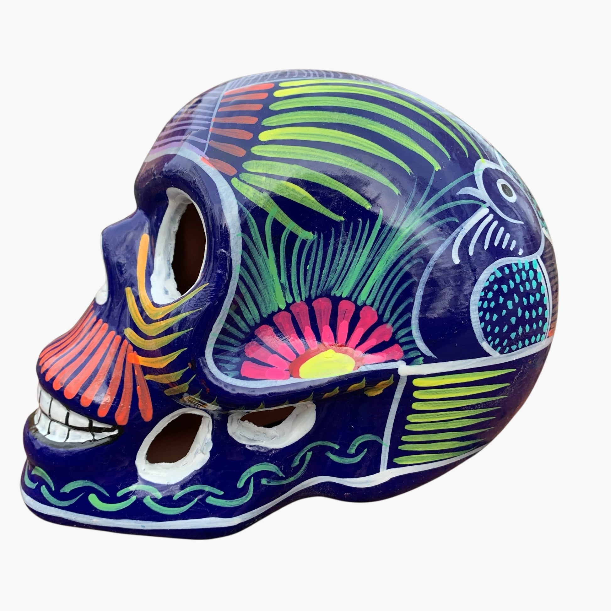Colorful Mexican Sugar skull purple with vibrant designs on a white background Side view