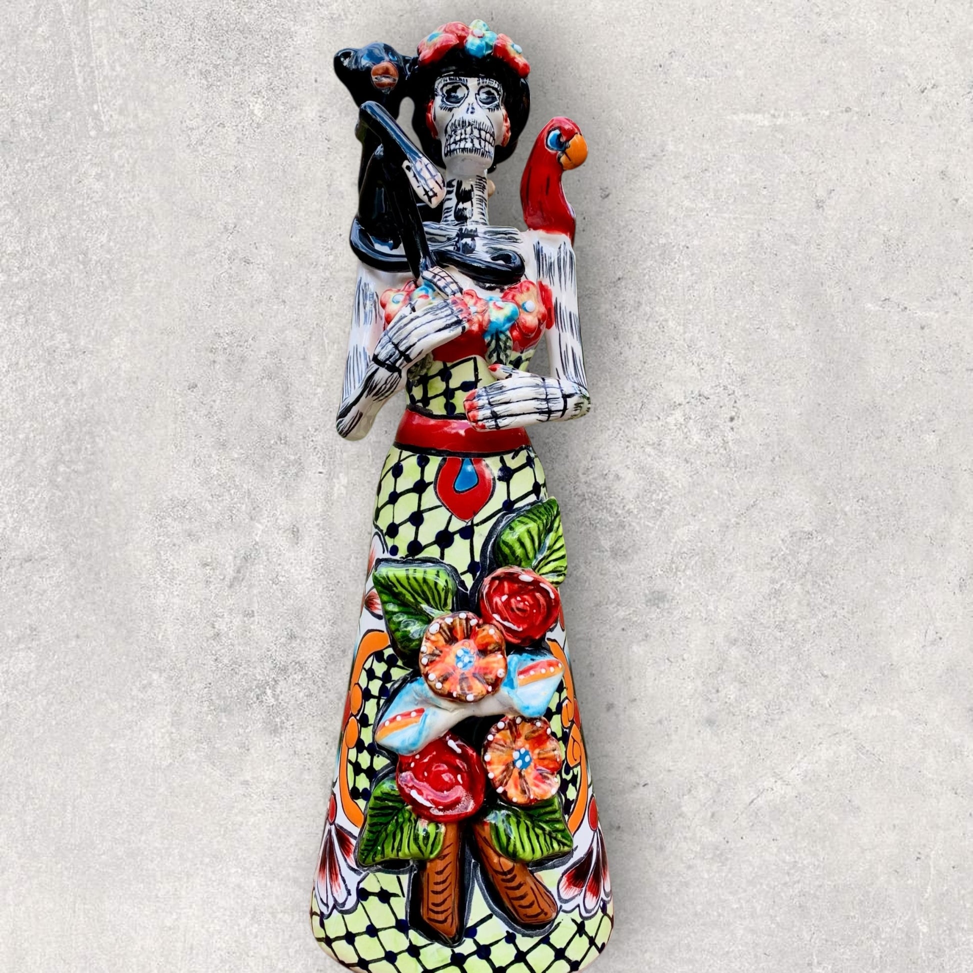 Talavera Frida holding her parrot and monkey friend