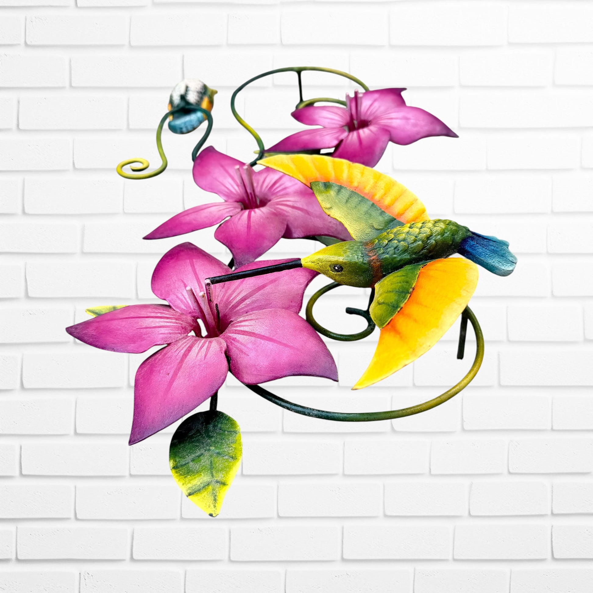 Decorative wall art with purple flowers and colorful hummingbirds on a white brick background bottom side view