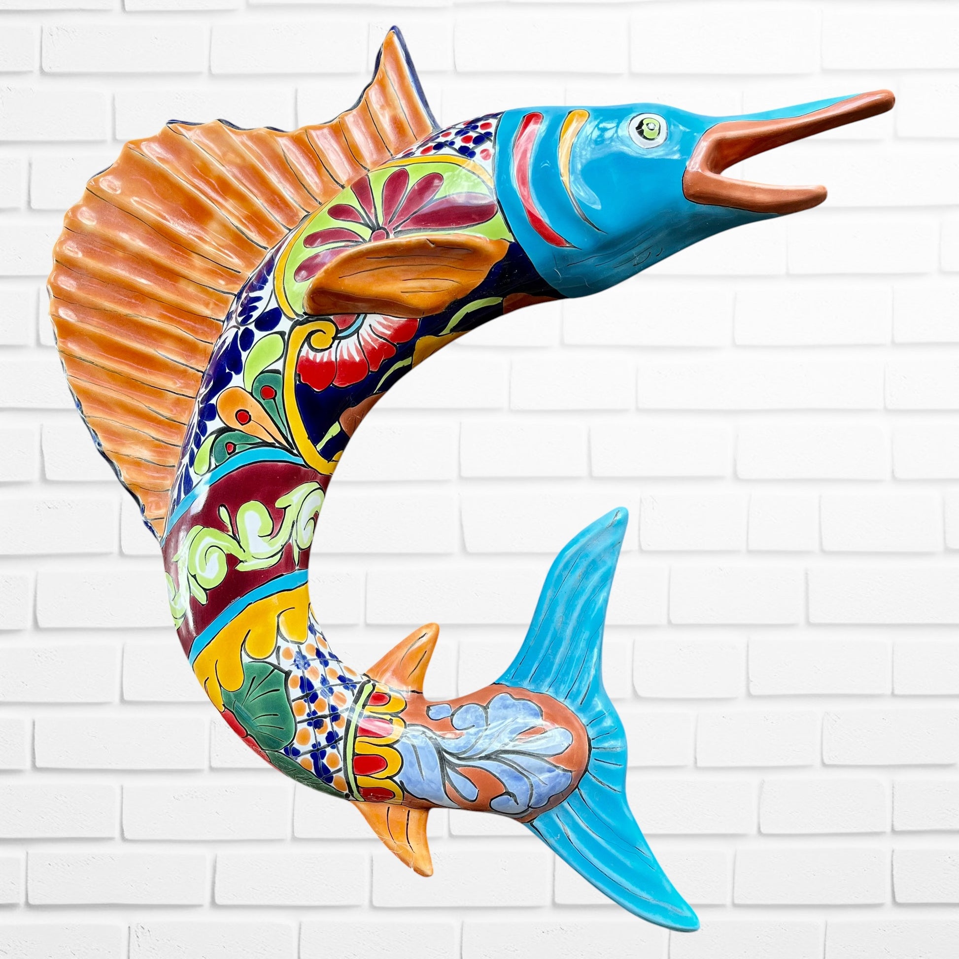 Colorful Mexican Talavera selfish sculpture against a white brick wall