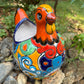 Colorful orange multi-color Mexican Talavera ceramic chicken shape planter on a natural background