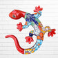 A colorful Talavera ceramic wall salamander lizard art piece with a glossy finish, featuring a red head and tail with a patterned body, displayed against a white brick wall background.