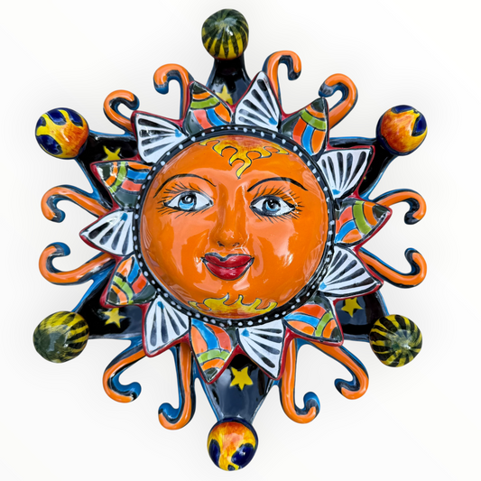 A colorful hand-painted Talavera ceramic sun wall decor piece with a smiling face, orange center, planets, and multicolored rays on a plain white background.