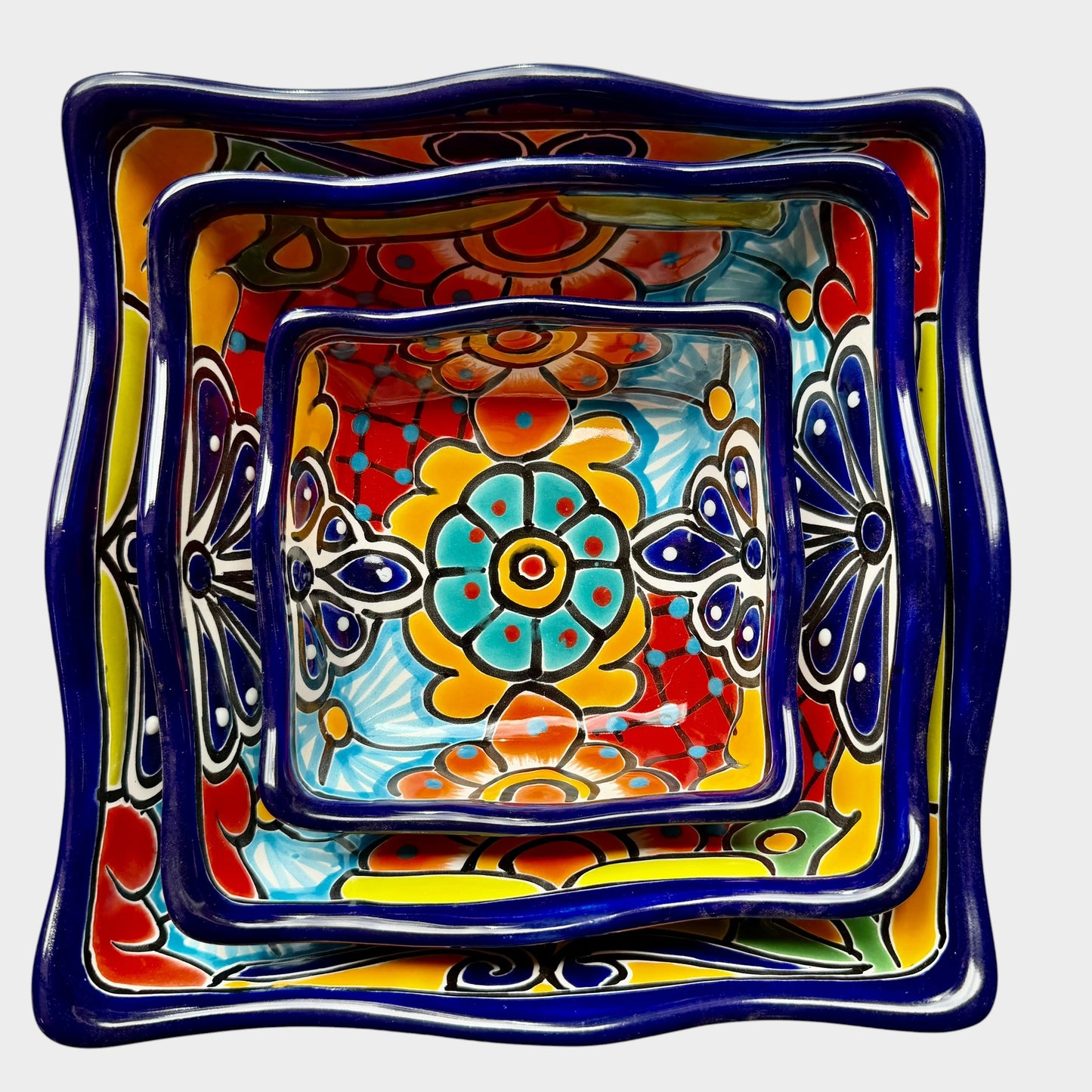 Three colorful talavera square nesting bowls with intricate patterns