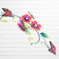 Decorative metal wall art with colorful flowers and butterflies on a white brick wall background three dimensional side view