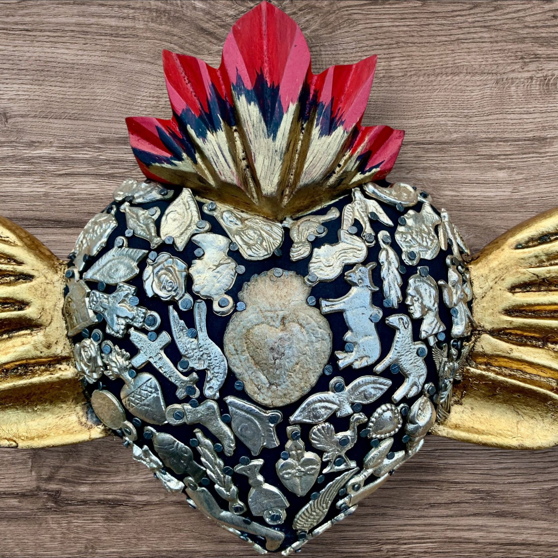 Milagros decorated sacred heart with wings center