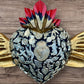 Milagros decorated sacred heart with wings center