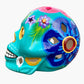 Colorful Mexican Sugar skull teal with vibrant designs on a white background side view