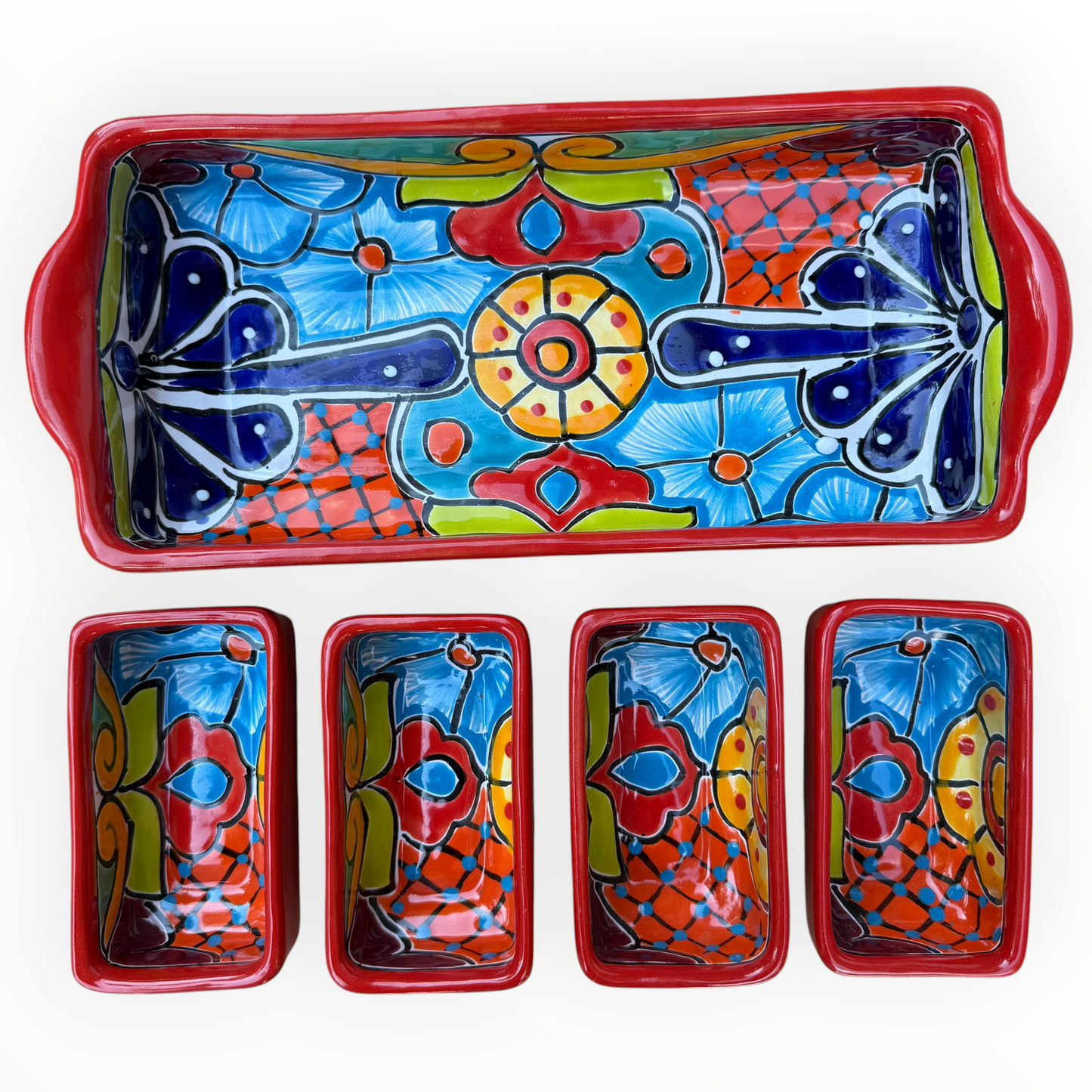 A red ceramic four-compartment serving tray with hand-painted talavera designs in blue, orange, green, and yellow on a white background, top view of compartments and tray.