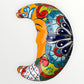 Colorful decorative crescent moon with intricate patterns on a white background curved side view
