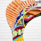 Colorful Mexican Talavera selfish sculpture against a white brick wall Body detail