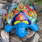 Colorful Mexican Talavera ceramic turtle figurine on a natural stone background Front