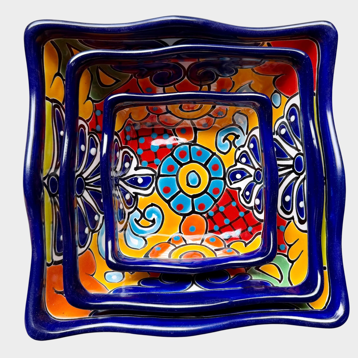 Three colorful talavera square nesting bowls with intricate patterns
