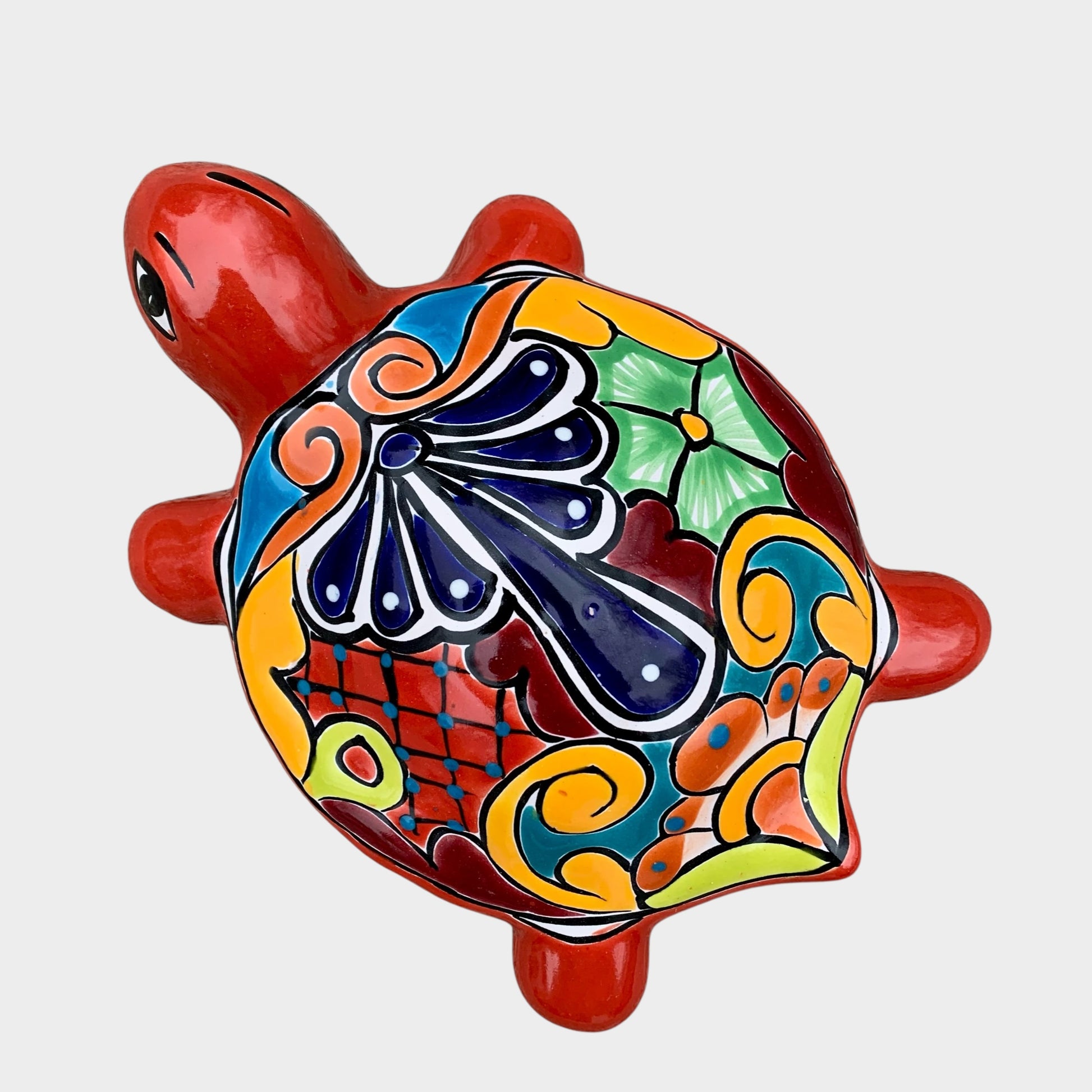 Colorful turtle-shaped figurine with decorative patterns on a white background