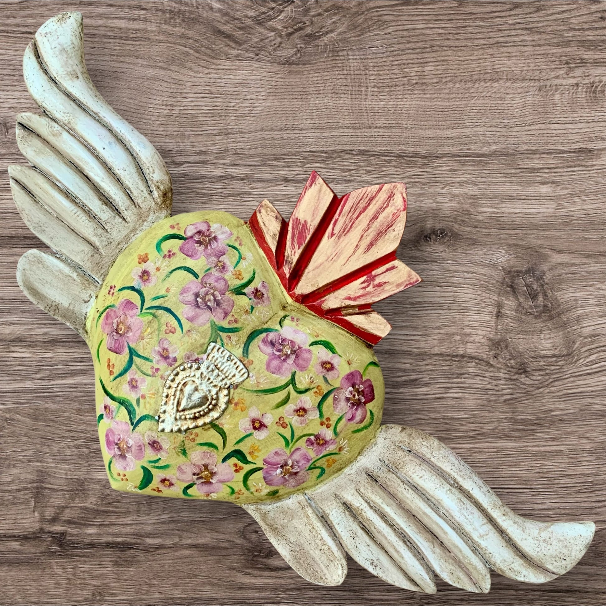 Milagros decorated sacred heart with wings