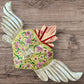 Milagros decorated sacred heart with wings