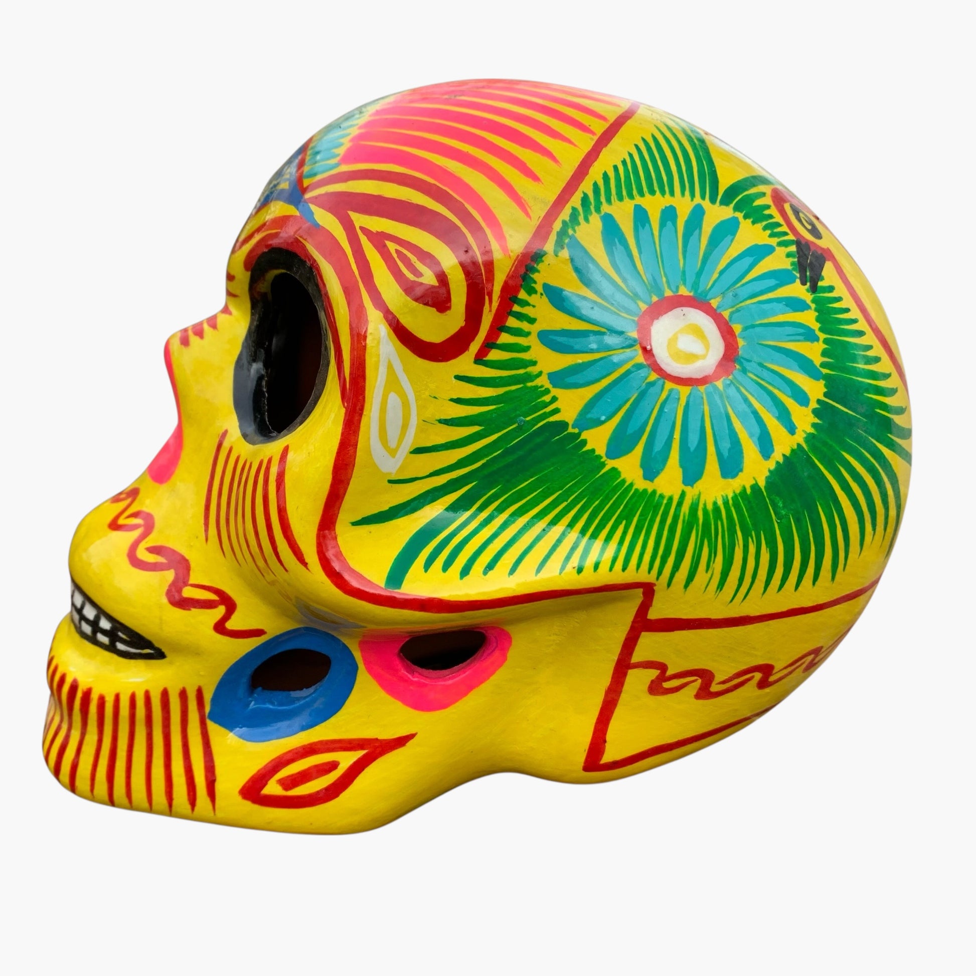 Yellow Mexican sugar skull with multicolored designs side view