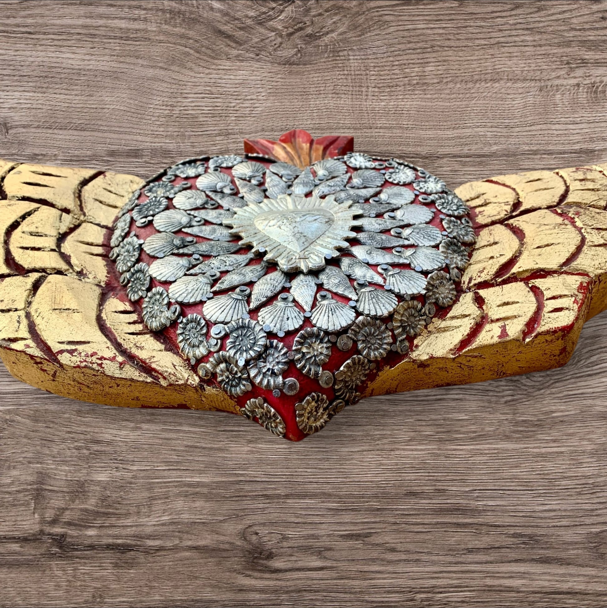 Winged Milagros sacred heart with center heart charm surrounded by sea shells View of thick sides