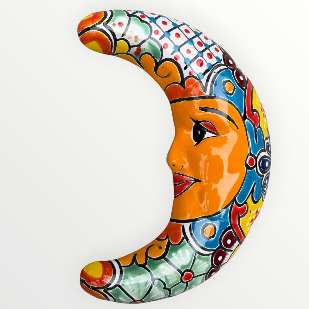 Decorative ceramic moon with colorful patterns on a white background face view